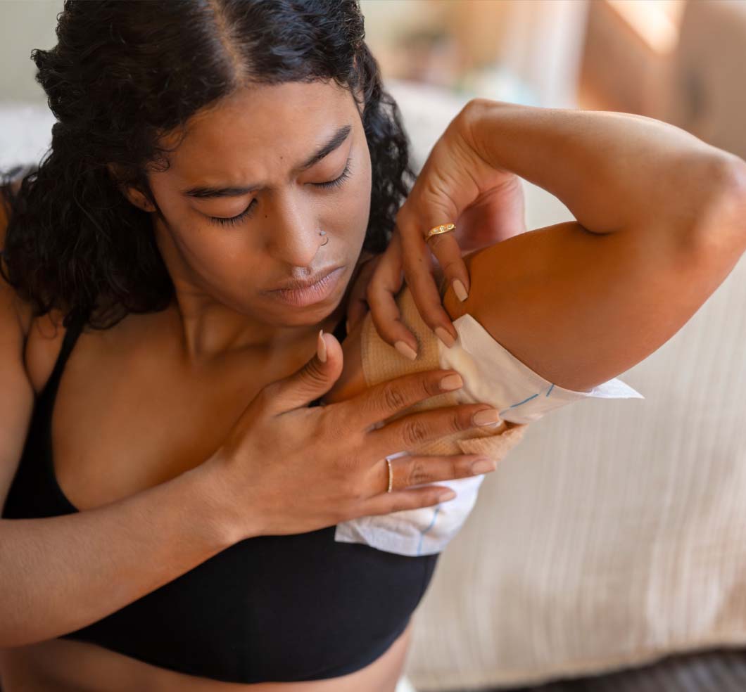 Person holding a bandage to underarm